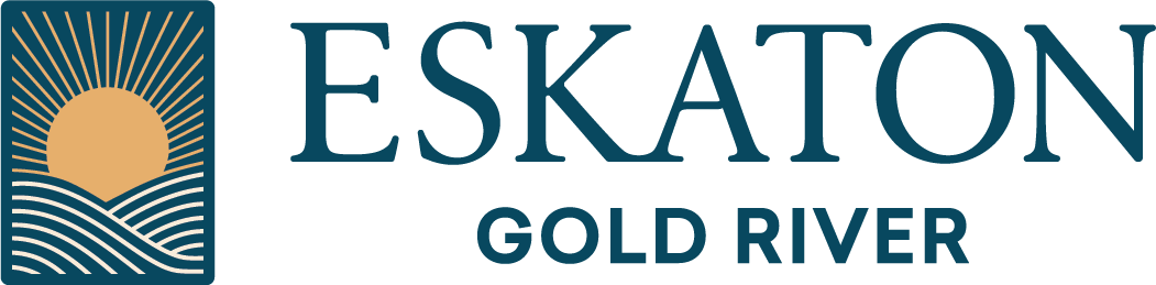 Eskaton Gold River logo featuring a stylized image of a gold sun rising over wavy lines, with ESKATON in large letters and GOLD RIVER below in smaller text.
