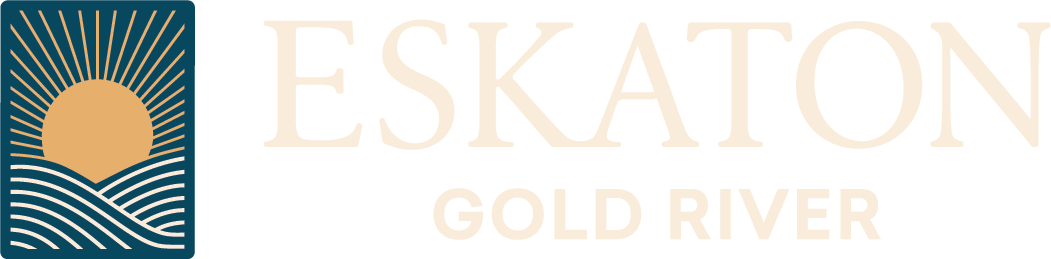 Logo for Eskaton Gold River featuring a sun rising over stylized waves to the left, with the words ESKATON in large letters and GOLD RIVER below in smaller text.