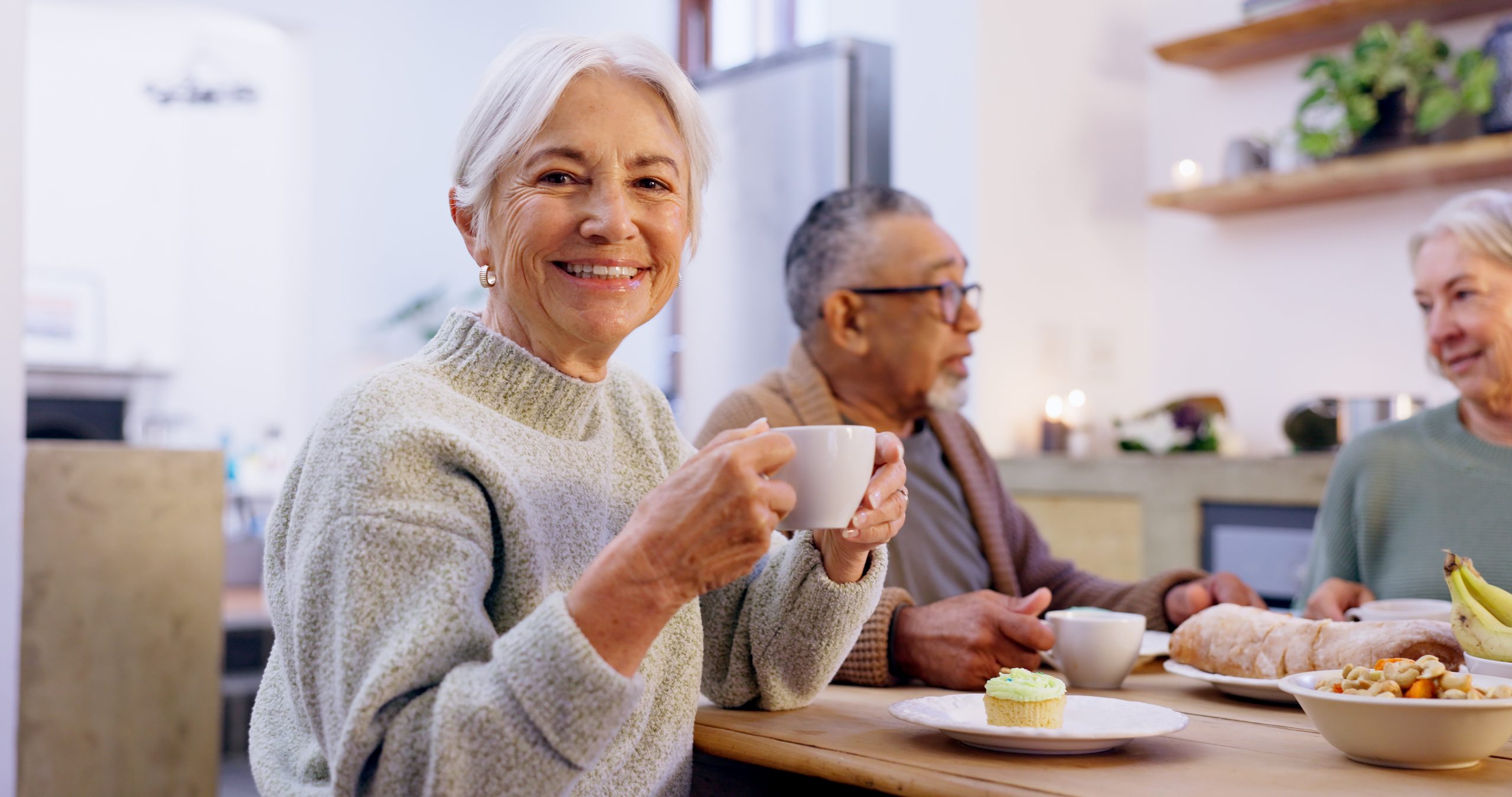 A woman enjoys a cup of coffee at Eskaton Village Roseville, a welcoming 55+ community designed for vibrant senior living.
