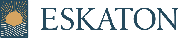 Eskaton logo featuring a golden sun rising over wavy lines, enclosed in a square, next to the word ESKATON in large, blue capital letters.